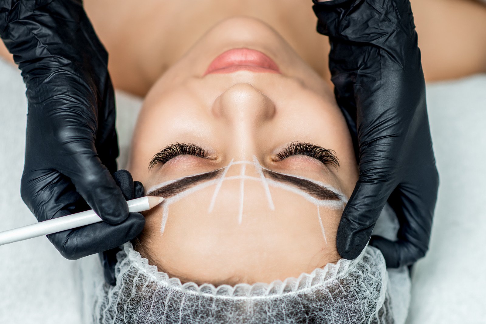 Image of someone getting permanent eyebrows.