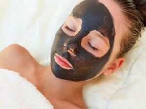 Image of a woman with her eyes closed enjoying her facial treatment.